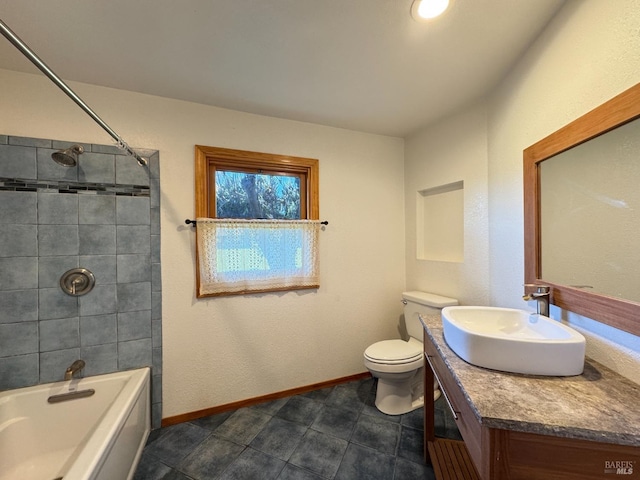 full bathroom featuring vanity, tiled shower / bath, and toilet