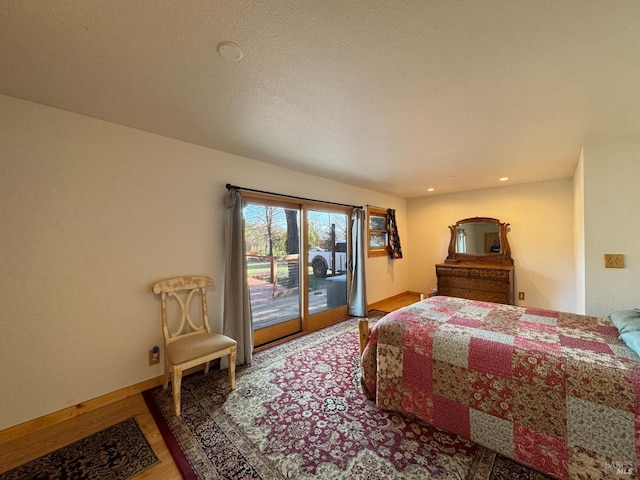 bedroom with hardwood / wood-style flooring and access to outside