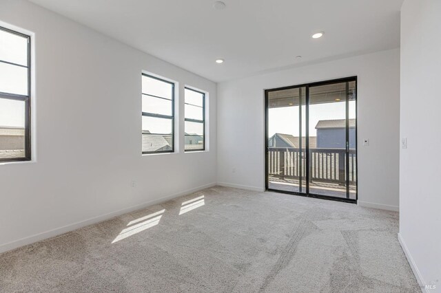 spare room featuring recessed lighting, baseboards, and carpet