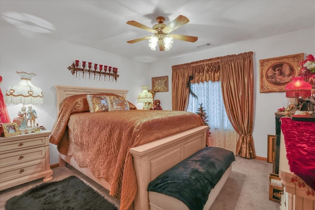 bedroom with light colored carpet, visible vents, ceiling fan, and baseboards