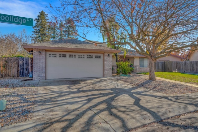 ranch-style home with a garage, driveway, fence, and brick siding