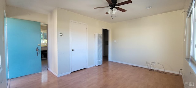 unfurnished bedroom featuring ceiling fan, a closet, and light hardwood / wood-style flooring