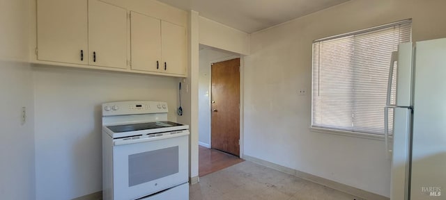 kitchen with white cabinets and white appliances