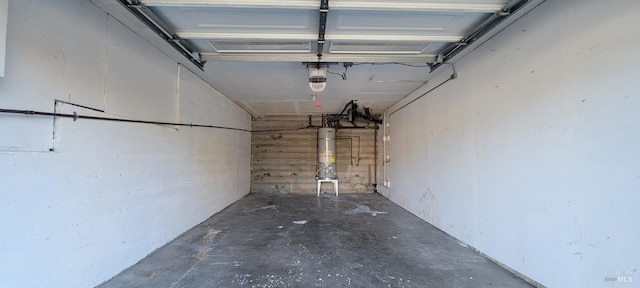 garage featuring a garage door opener and water heater