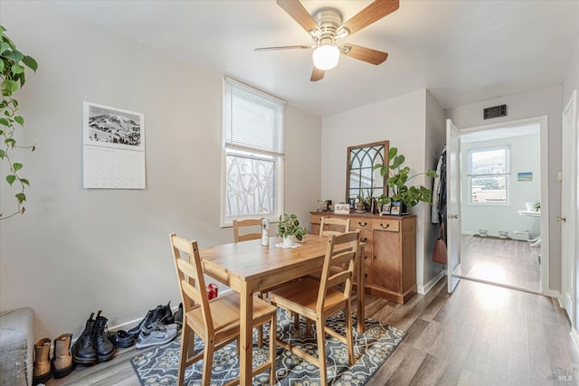 dining space featuring ceiling fan and light wood-type flooring