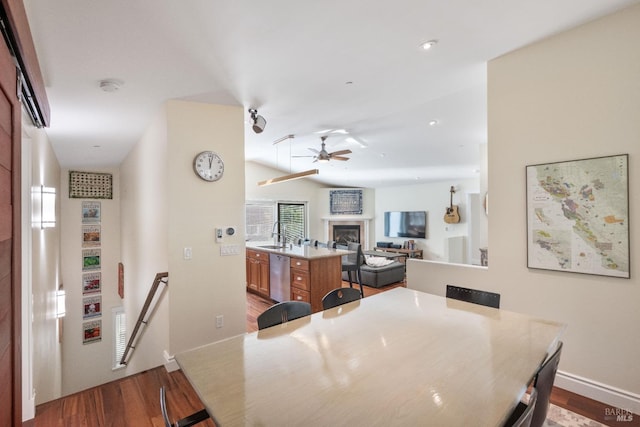 dining room featuring hardwood / wood-style flooring, ceiling fan, and sink