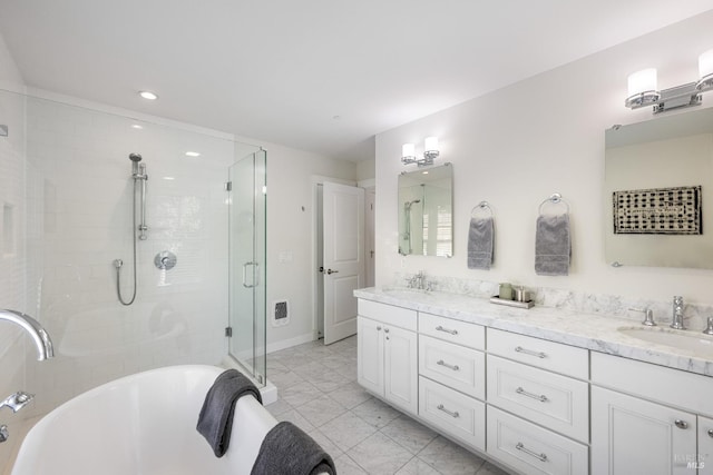 bathroom featuring vanity and separate shower and tub