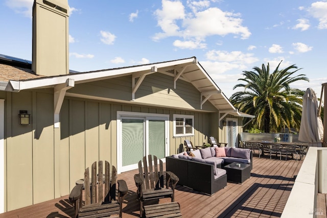 wooden deck with an outdoor living space