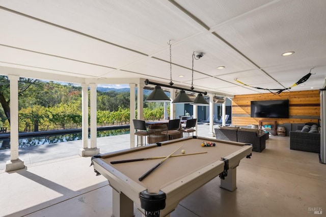 game room with plenty of natural light, concrete flooring, and pool table