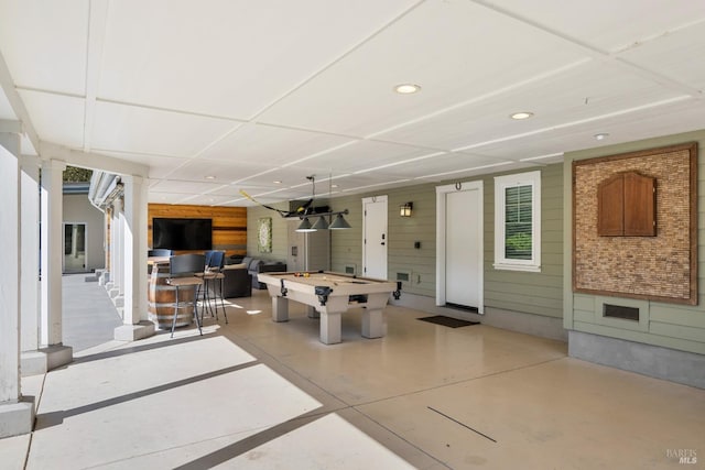 playroom featuring wood walls and billiards