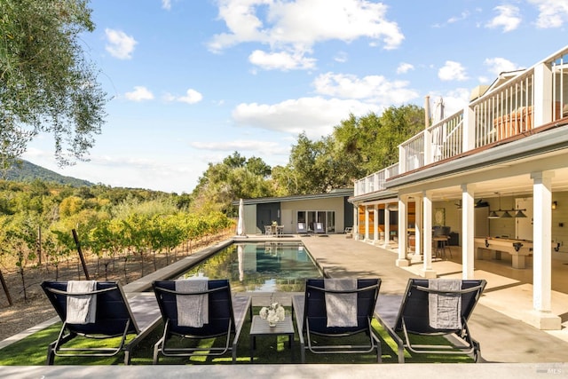 view of pool with a patio and ceiling fan