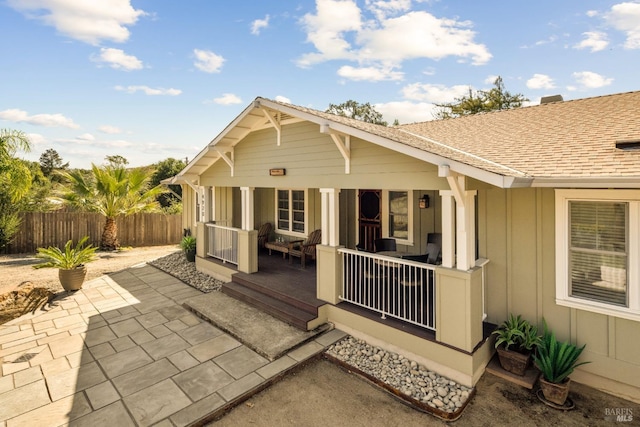 back of property with a porch