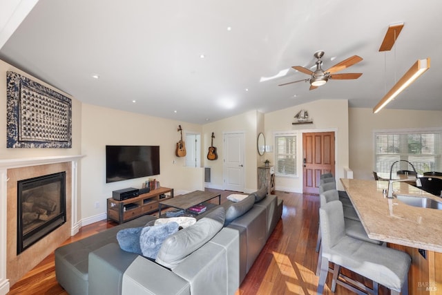 living room with dark hardwood / wood-style flooring, ceiling fan, lofted ceiling, and sink