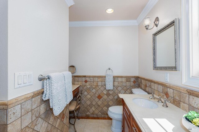 bathroom with vanity, toilet, tile walls, and ornamental molding