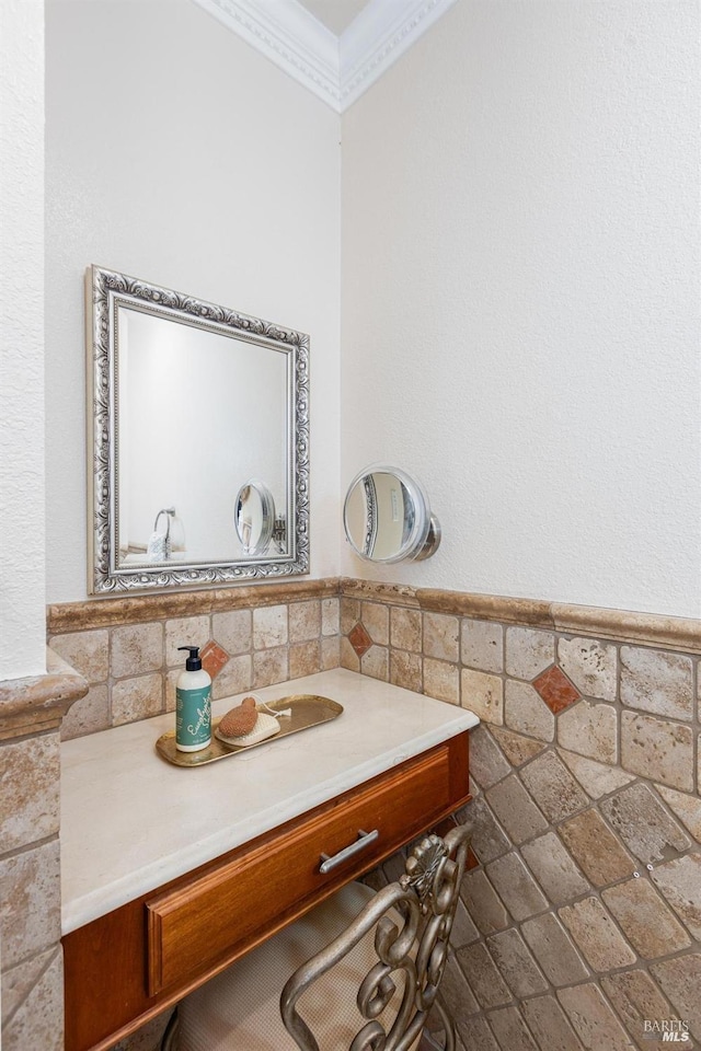 bathroom featuring vanity, tile walls, and ornamental molding