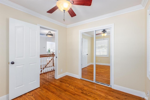 empty room featuring hardwood / wood-style floors and crown molding