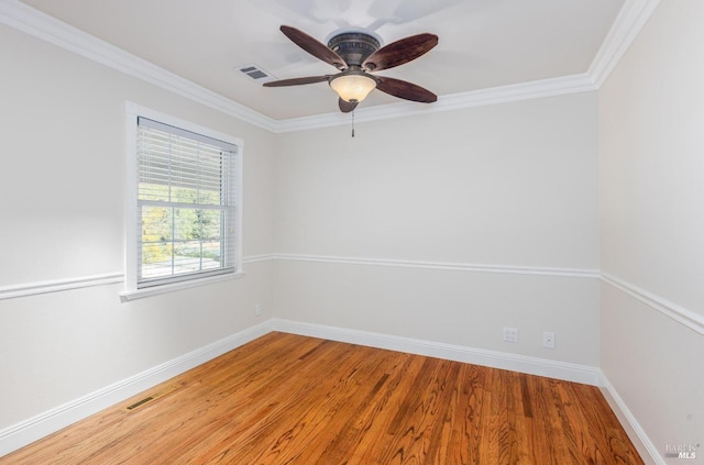 empty room featuring wood-type flooring, ceiling fan, and ornamental molding