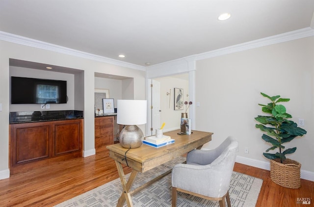 office area featuring light hardwood / wood-style floors and crown molding