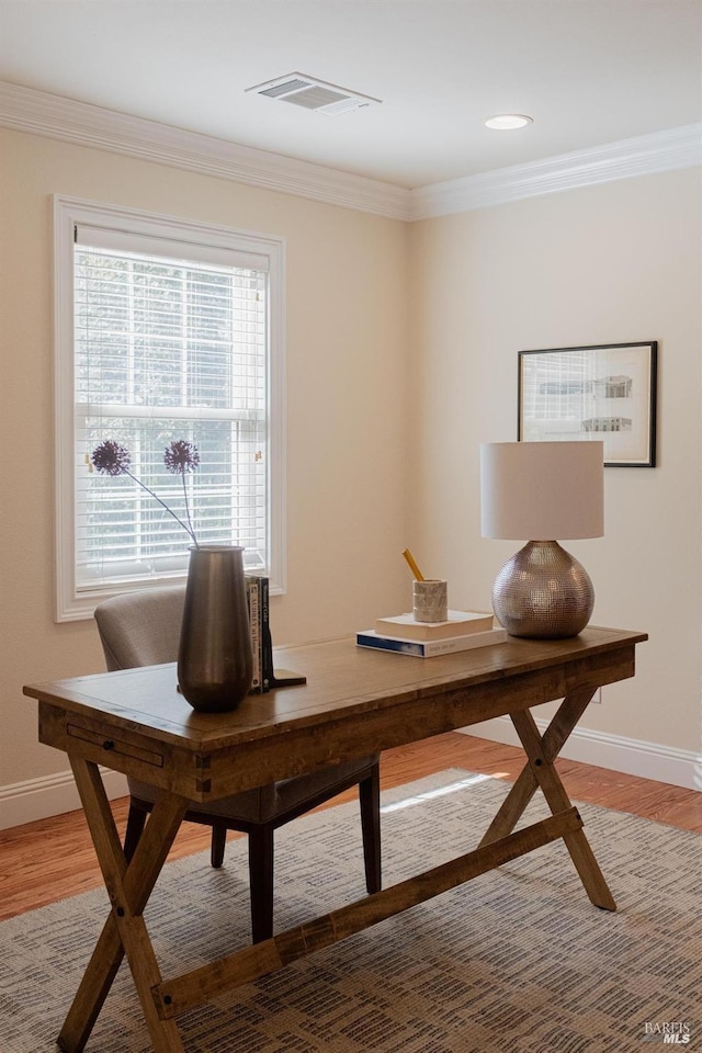 office area featuring hardwood / wood-style floors and ornamental molding