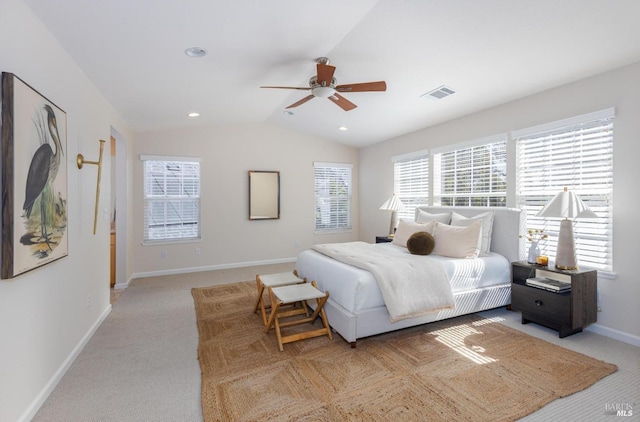 bedroom featuring light colored carpet, vaulted ceiling, and ceiling fan