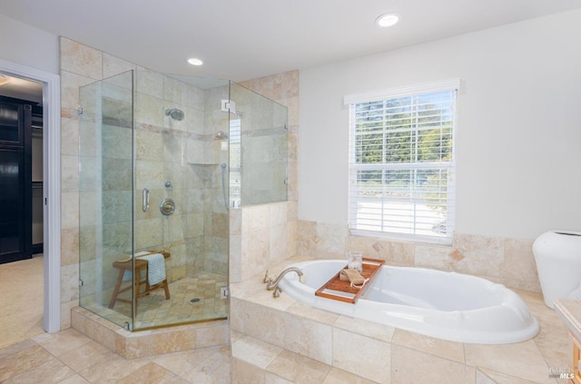 bathroom featuring separate shower and tub