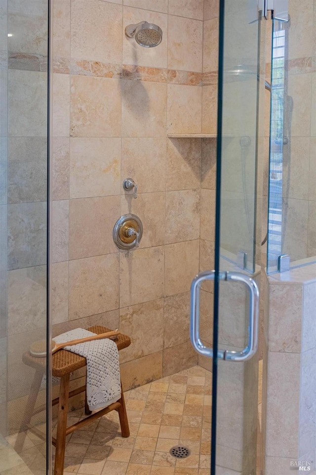 bathroom with a shower with door