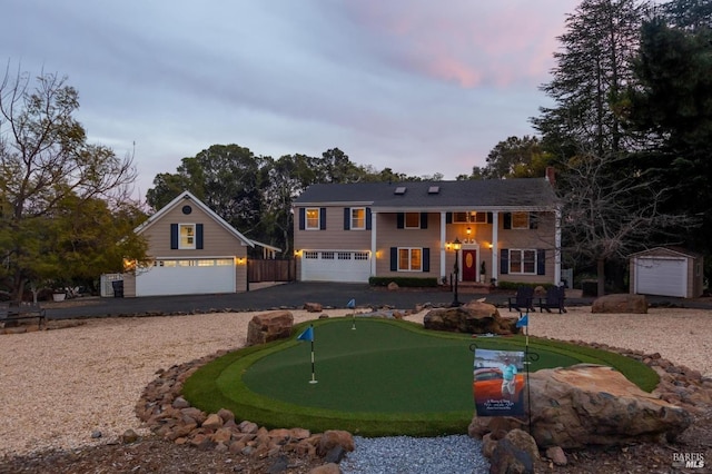 view of front of property featuring a shed and a garage