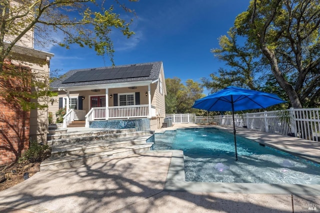 view of swimming pool with covered porch