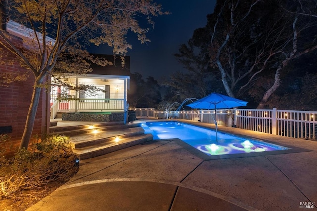 pool at night with a patio