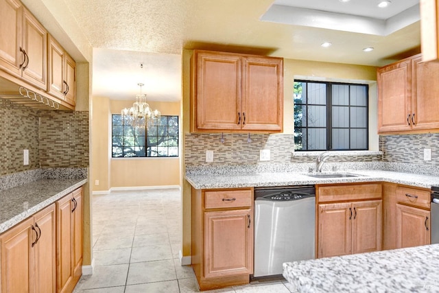 kitchen featuring dishwasher, sink, a chandelier, decorative light fixtures, and decorative backsplash