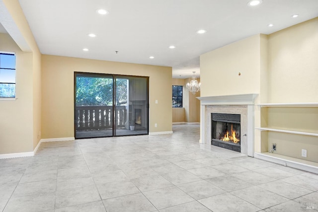 unfurnished living room featuring a chandelier and light tile patterned floors