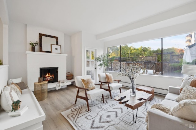 living room with light hardwood / wood-style floors and a baseboard radiator