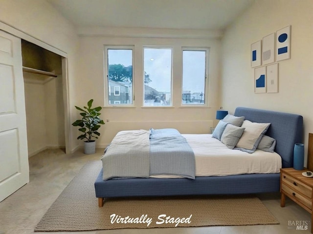 bedroom with a closet and light colored carpet