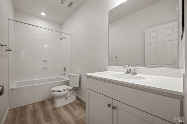 full bathroom with hardwood / wood-style flooring, vanity, toilet, and tub / shower combination