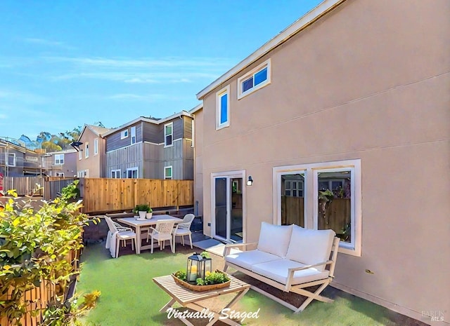 rear view of property featuring outdoor lounge area and a patio area