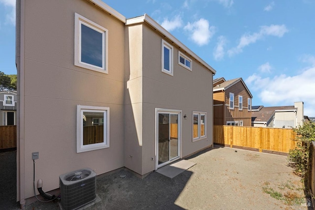 back of house with a patio area and central air condition unit