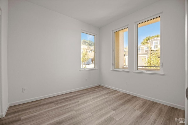 unfurnished room with light hardwood / wood-style flooring