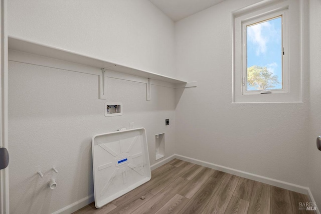 laundry room with hookup for a gas dryer, hookup for a washing machine, hookup for an electric dryer, and light wood-type flooring