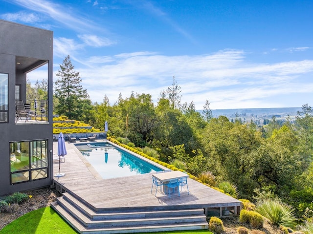 view of pool with a wooden deck