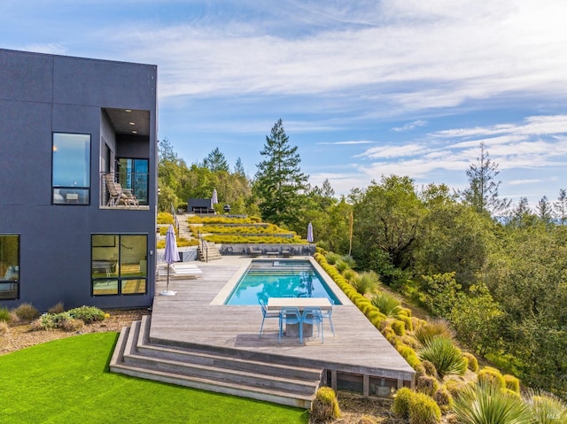 view of swimming pool with a wooden deck