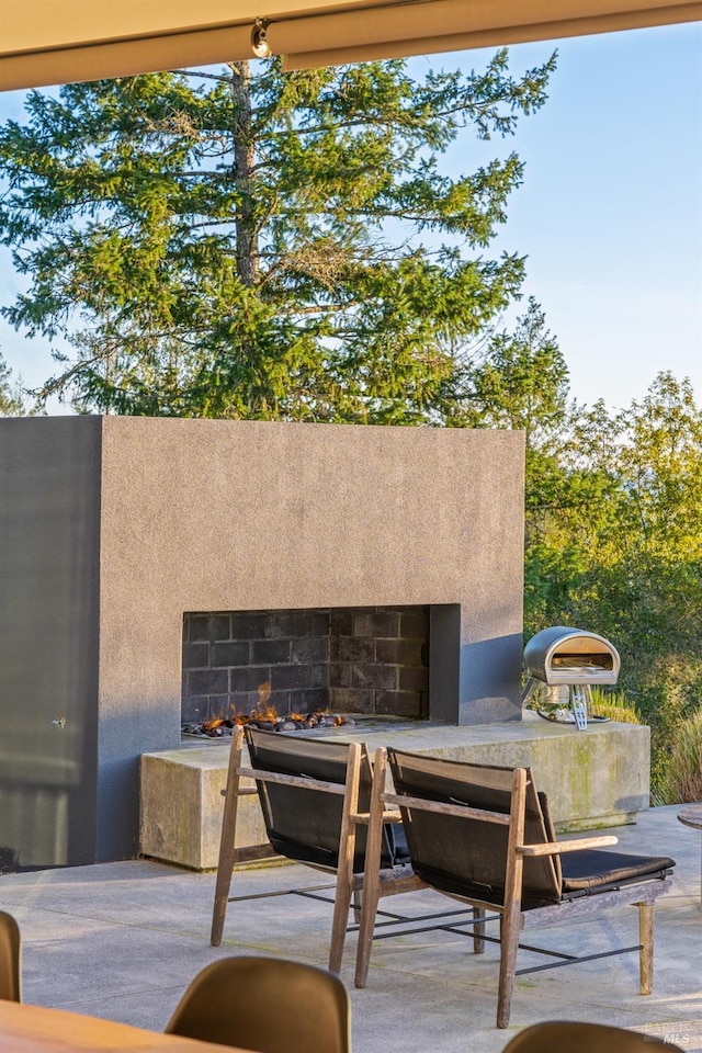 view of patio featuring exterior fireplace