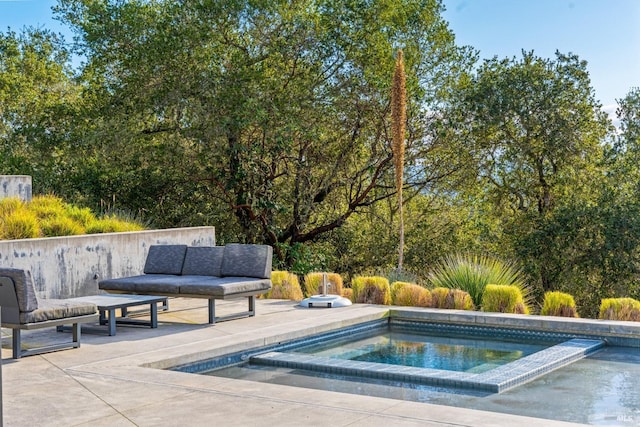 view of swimming pool featuring an in ground hot tub and a patio area