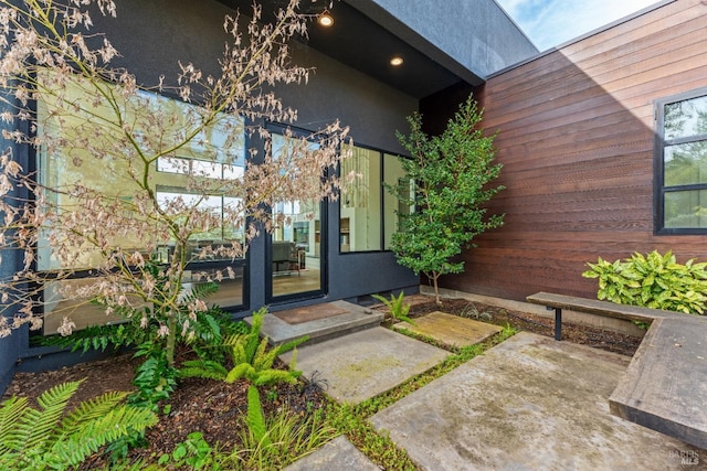 view of exterior entry with a patio area