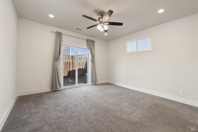 unfurnished room featuring carpet, visible vents, and baseboards