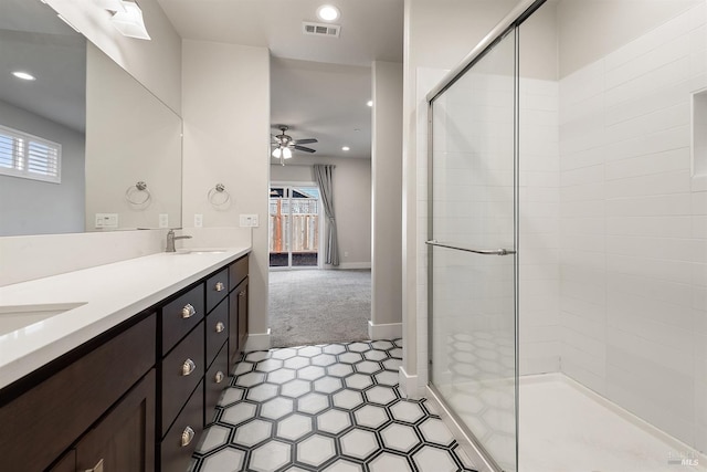 full bath featuring recessed lighting, visible vents, a ceiling fan, a sink, and a shower stall