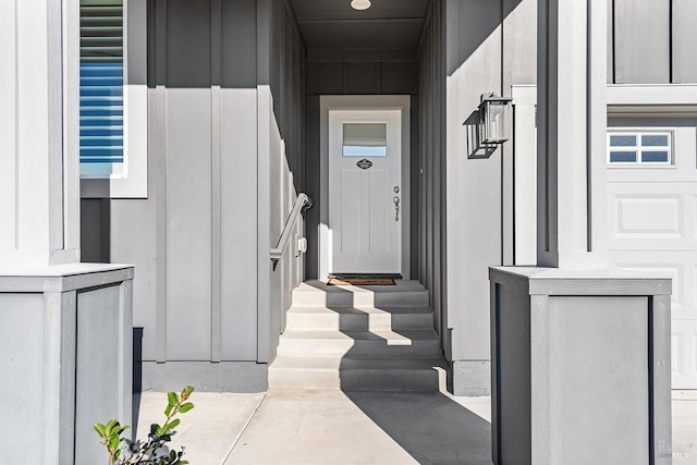 view of exterior entry with board and batten siding