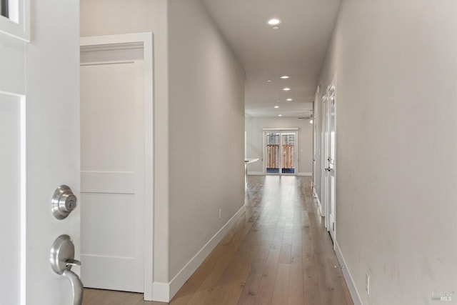 hall featuring recessed lighting, baseboards, and hardwood / wood-style flooring