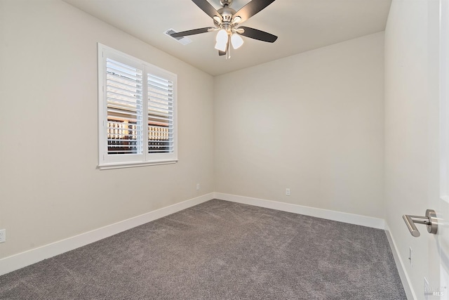 unfurnished room with dark colored carpet, visible vents, ceiling fan, and baseboards