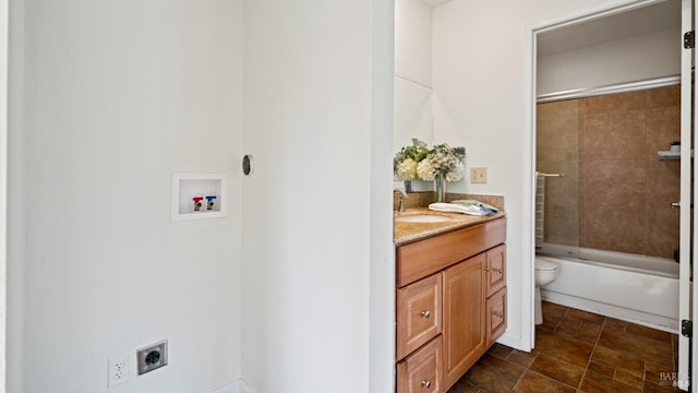 full bathroom featuring vanity, toilet, and tiled shower / bath