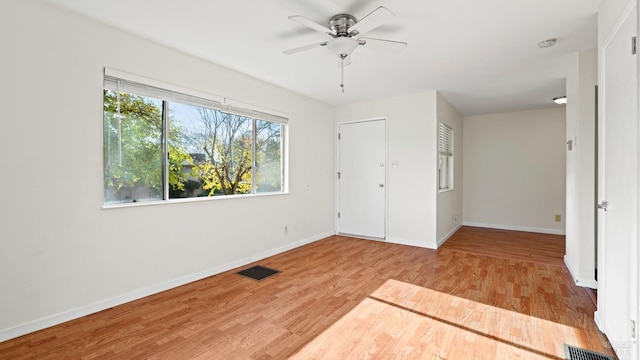 empty room featuring ceiling fan and light wood-type flooring